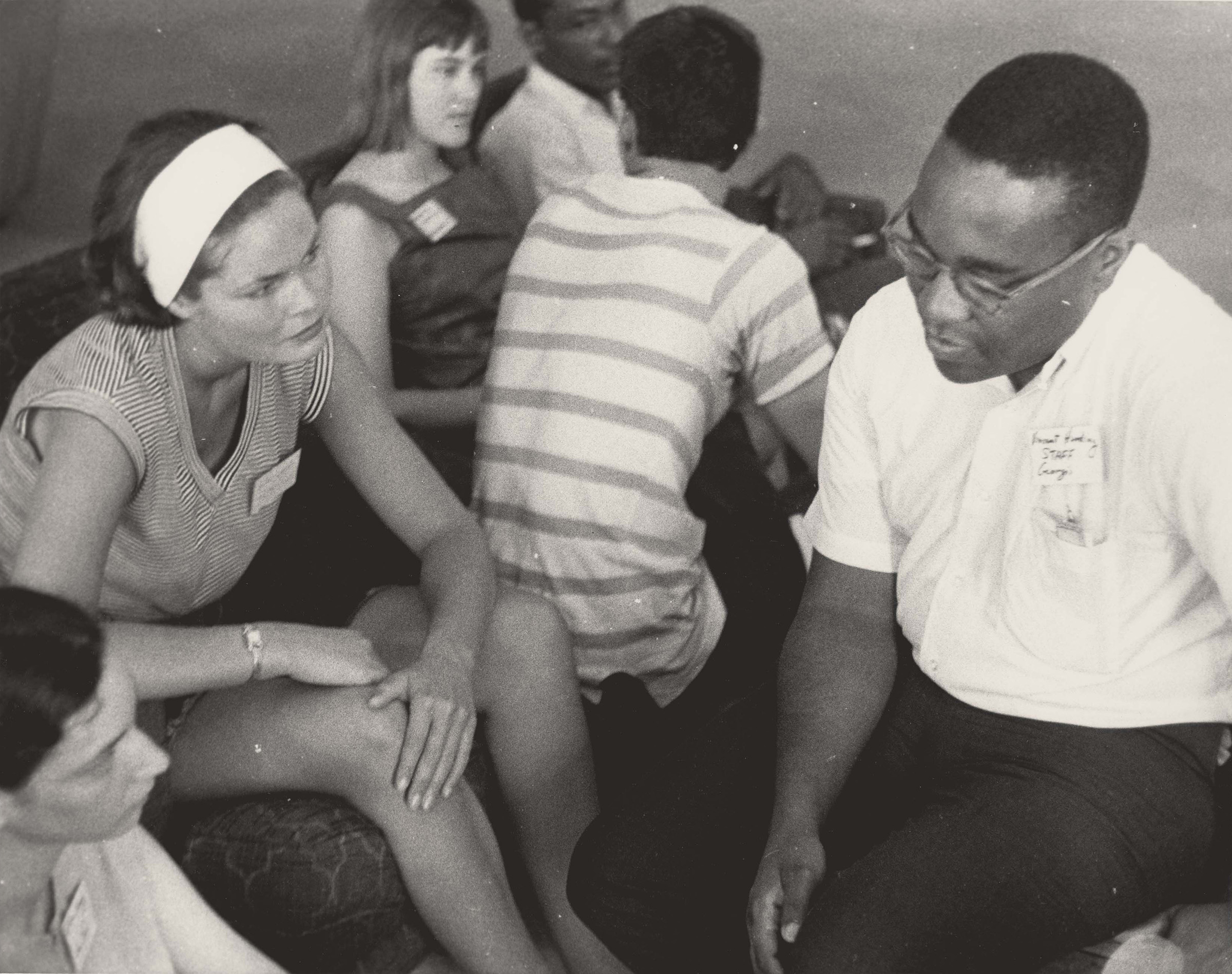 Volunteers at Orientation, June 1964. Photograph by Herbert Randall. SNCC orientation staff member, the Reverend Dr. Vincent Harding, talks to two volunteers at the Freedom Summer orientation session. M351 Herbert Randall Freedom Summer Photographs, Historical Manuscripts, The University of Southern Mississippi.