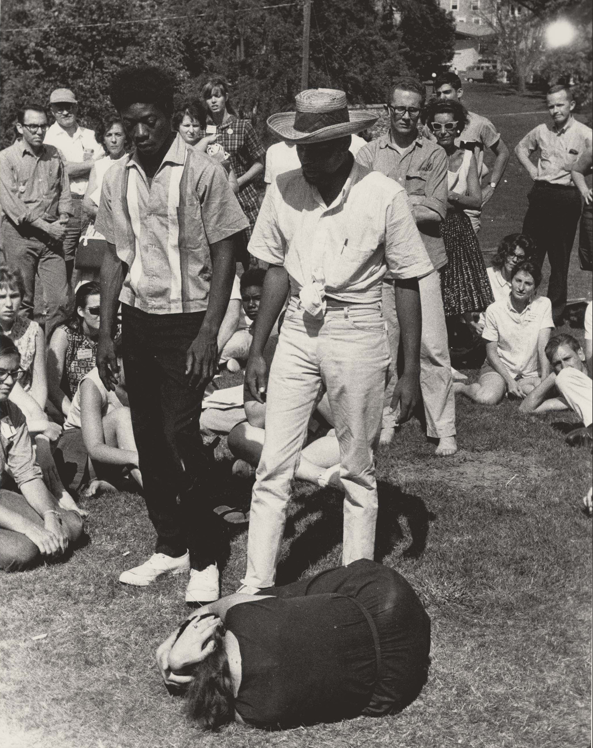 Demonstration of Nonviolent Self-defense, June 1964. Photograph by Herbert Randall. SNCC Field Secretaries Bruce Gordon (left), Cordell Hull Reagon (right), and a female volunteer, demonstrate how Freedom Summer volunteers should protect themselves from physical assault. This training was part of the Freedom Summer orientation held on the campus of Western College for Women in Oxford, Ohio, between June 22-27, 1964. M351 Herbert Randall Freedom Summer Photographs, Historical Manuscripts, The University of Southern Mississippi.