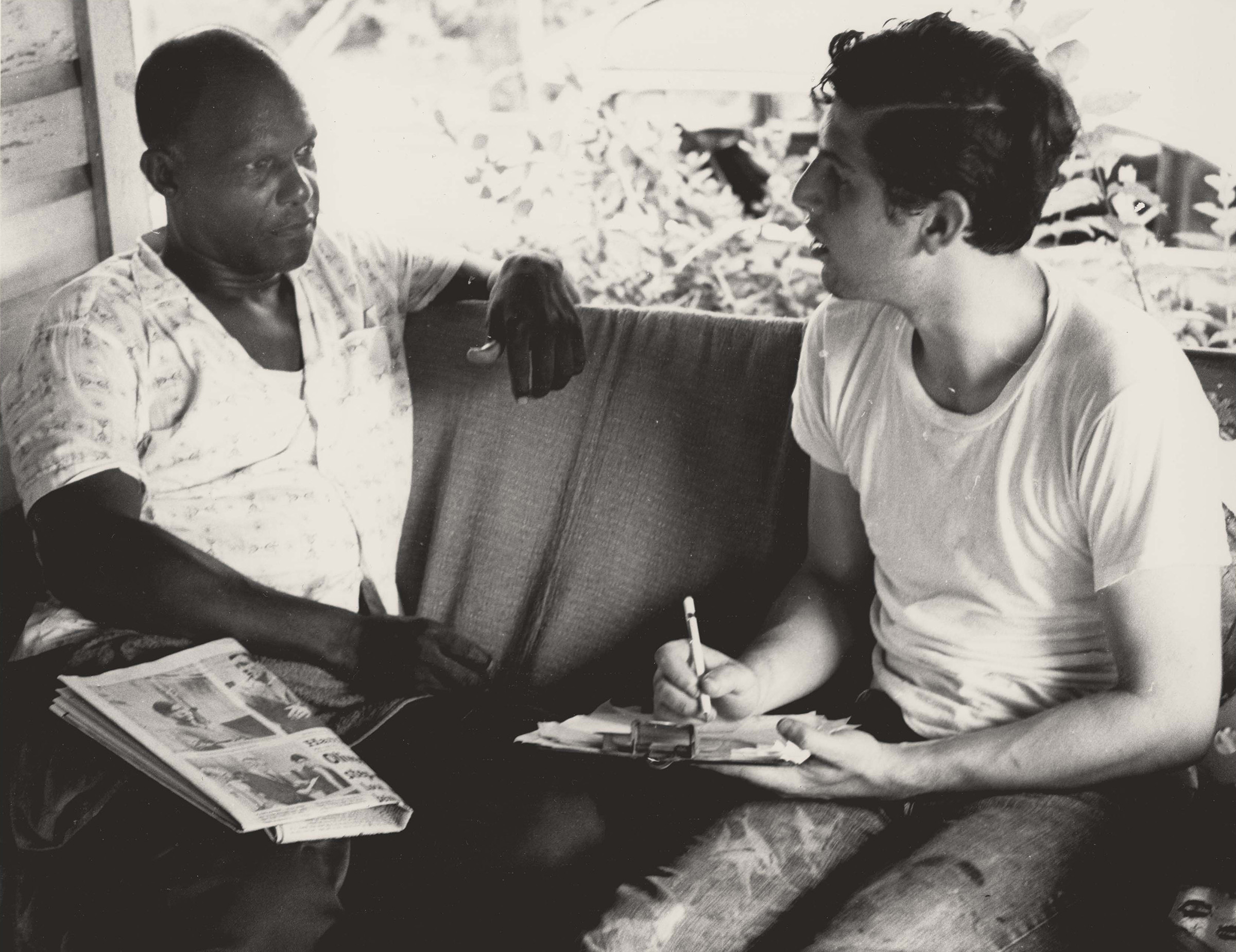 Voter Registration Canvassing, July 1964. Photograph by Herbert Randall. Horace Laurence (left) and Freedom Summer volunteer Dick Landerman (right) discuss voting rights while sitting on Laurence's front porch on Fairley Street in Hattiesburg, Mississippi, during Freedom Summer. M351 Herbert Randall Freedom Summer Photographs, Historical Manuscripts, The University of Southern Mississippi.